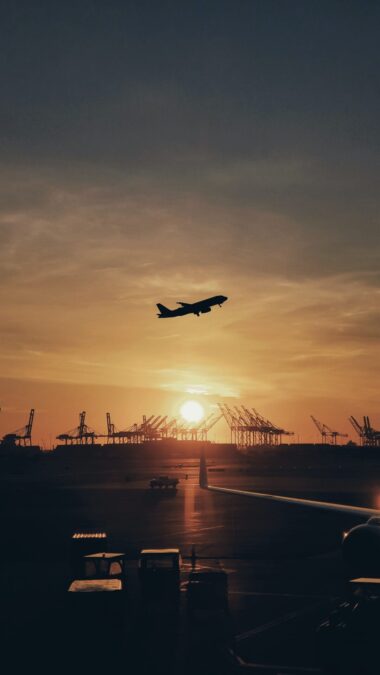 Departing plane at sunset